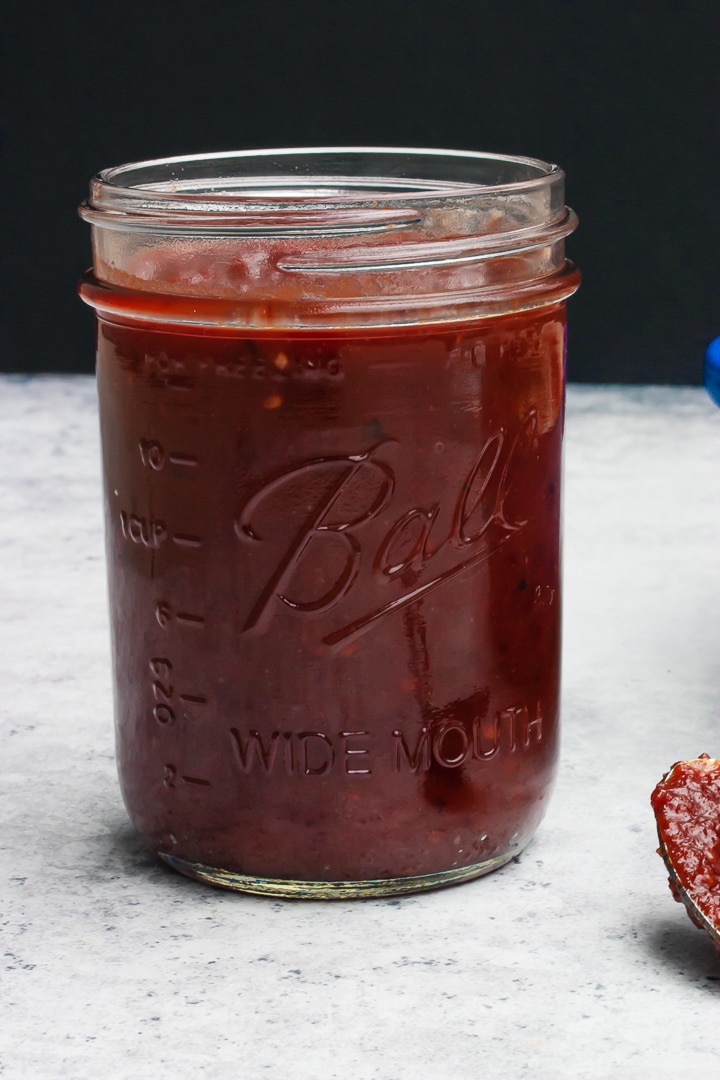 Chipotle barbecue sauce in a mason jar with a black background