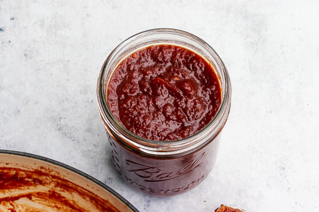 barbecue sauce in a glass mason jar on a white background