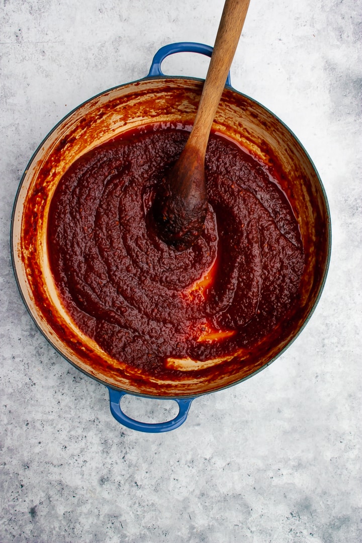 Finished, thickened sauce in a Braiser pan on a blue-grey background