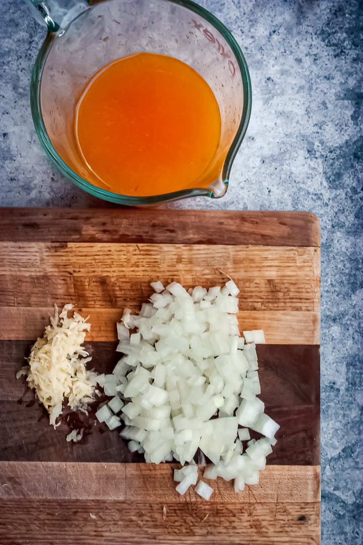 chopped onion, garlic, and freshly squeezed juice on a cutting board
