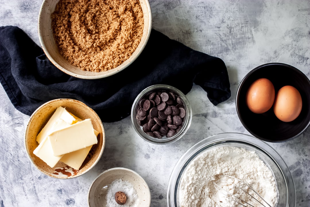 ingredients for blondie recipe in different size bowls with a napkin