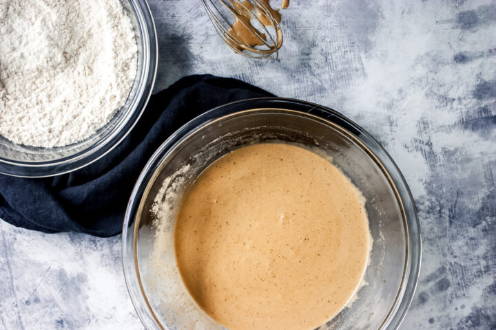 wet mixture and flour in bowls with a napkin on the side