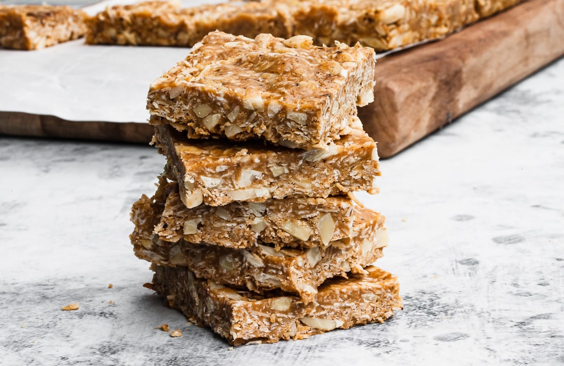 4 bars stacked on top of each other with a cutting board in the background