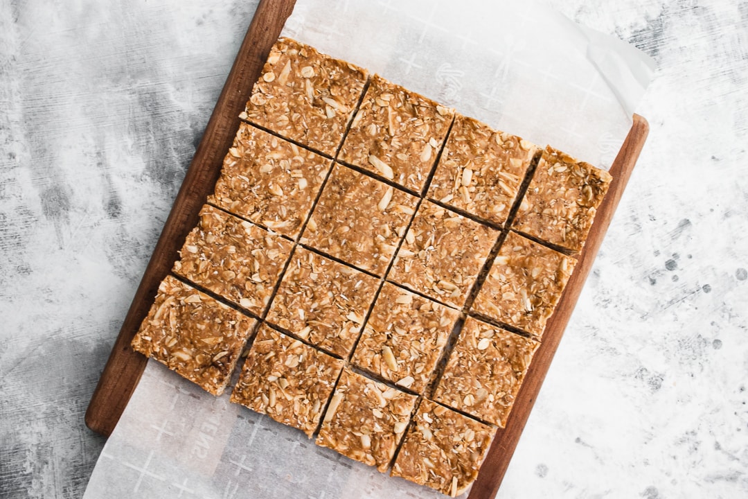 granola bars cut into 16 squares on a cutting board