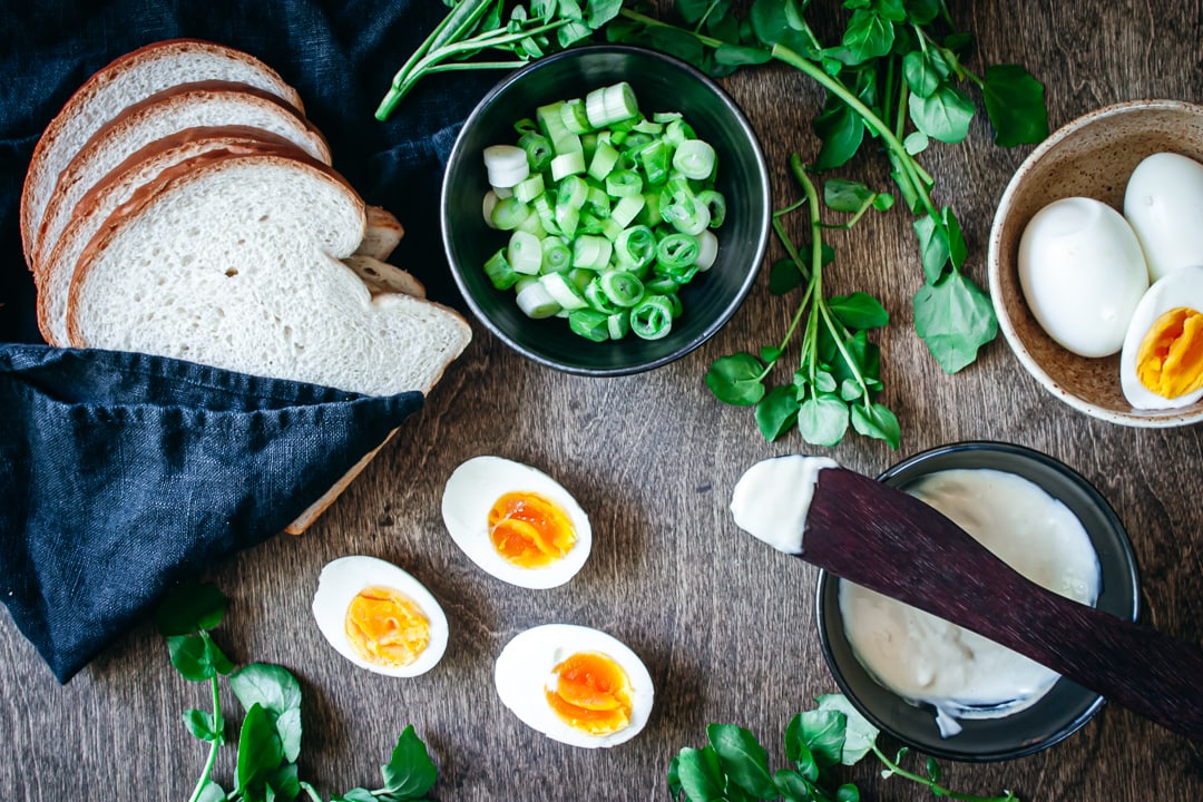 Ingredients in different size bowls and on a wood background