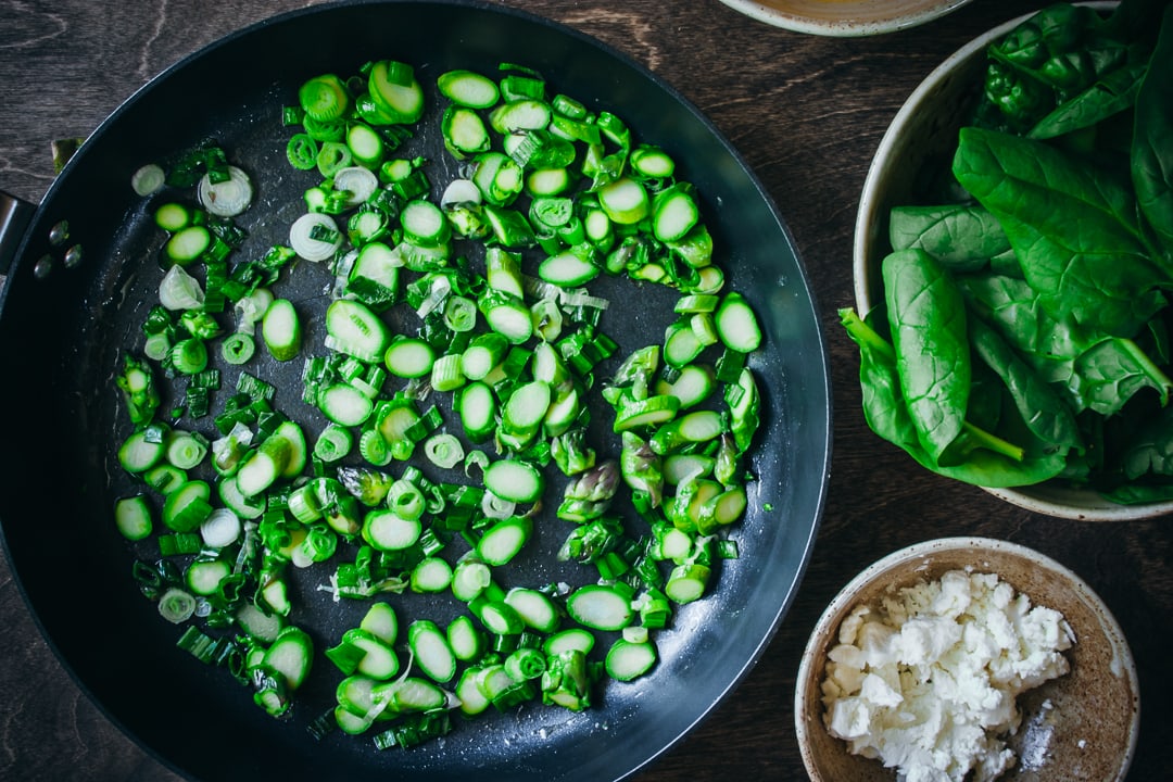 sautéed asparagus and spring onions in a skillet