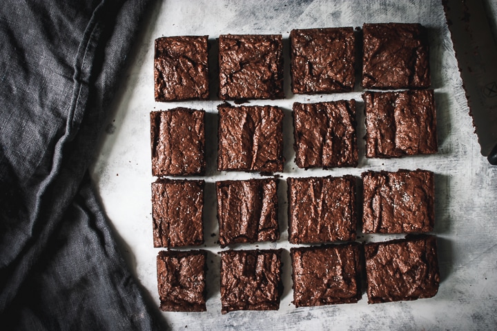 brownies cut into 16 squares after baking with a napkin on the side