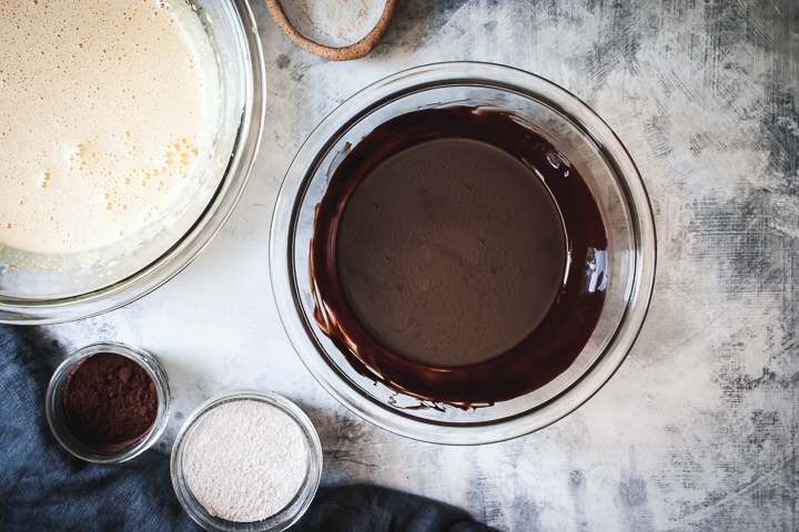 melted chocolate and butter in a glass bowl and mixed sugars and eggs in a separate glass bowl