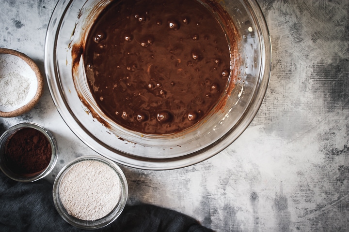 chocolate and egg mixture combined with rye flour and cocoa powder on the side