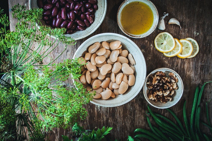 ingredients for the dressing and salad in different size white bowls