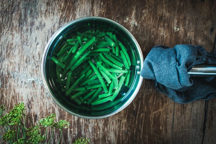 cooked green beans in a pot of water