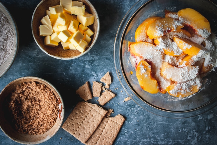 peaches with arrowroot powder and sugar in a bowl with butter and sugar on the side