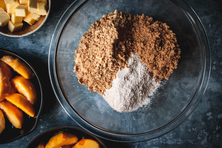 dry ingredients for crumble in a bowl with butter on the side