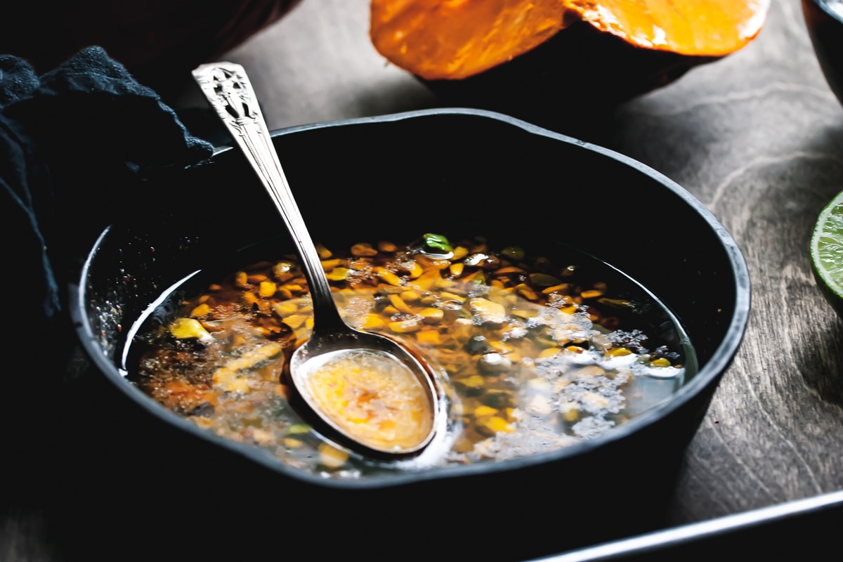 pistachio brown butter in a cast iron skillet with a spoon