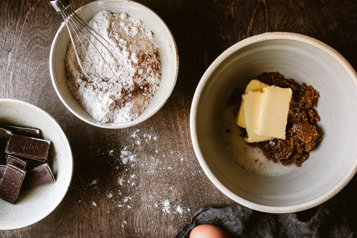 dry ingredients with a whisk in a small bowl and butter and sugars in a large bowl
