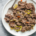 slow cooker Italian beef on a plate with a fork