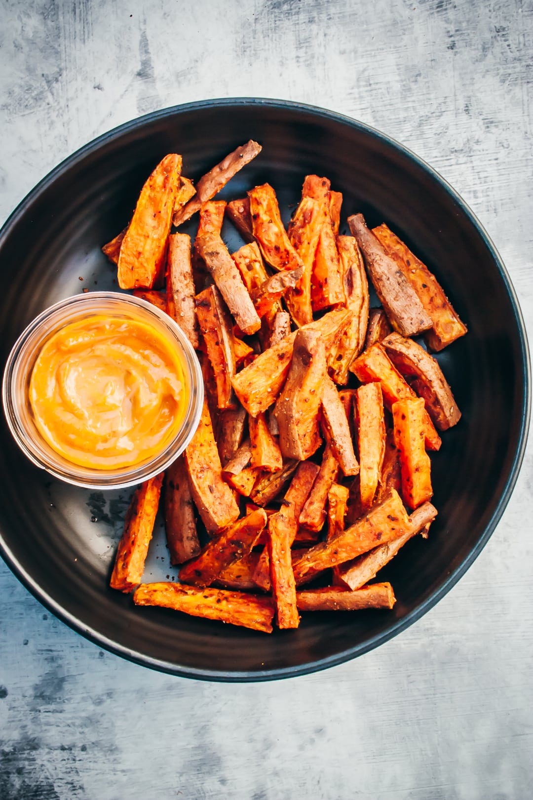 Oven-baked Sweet Potato fries in a serving bowl with a side of chipotle mayo