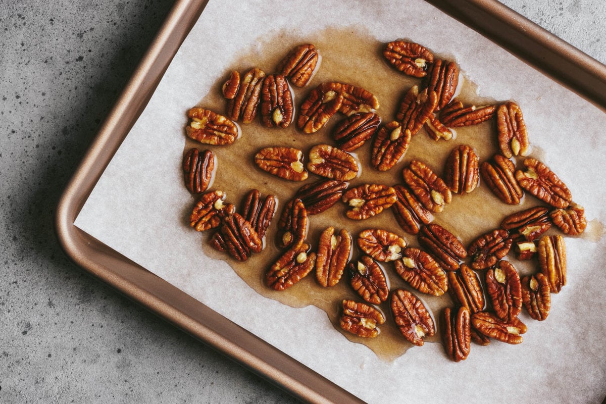 pecan mixture spread evenly on a sheet pan