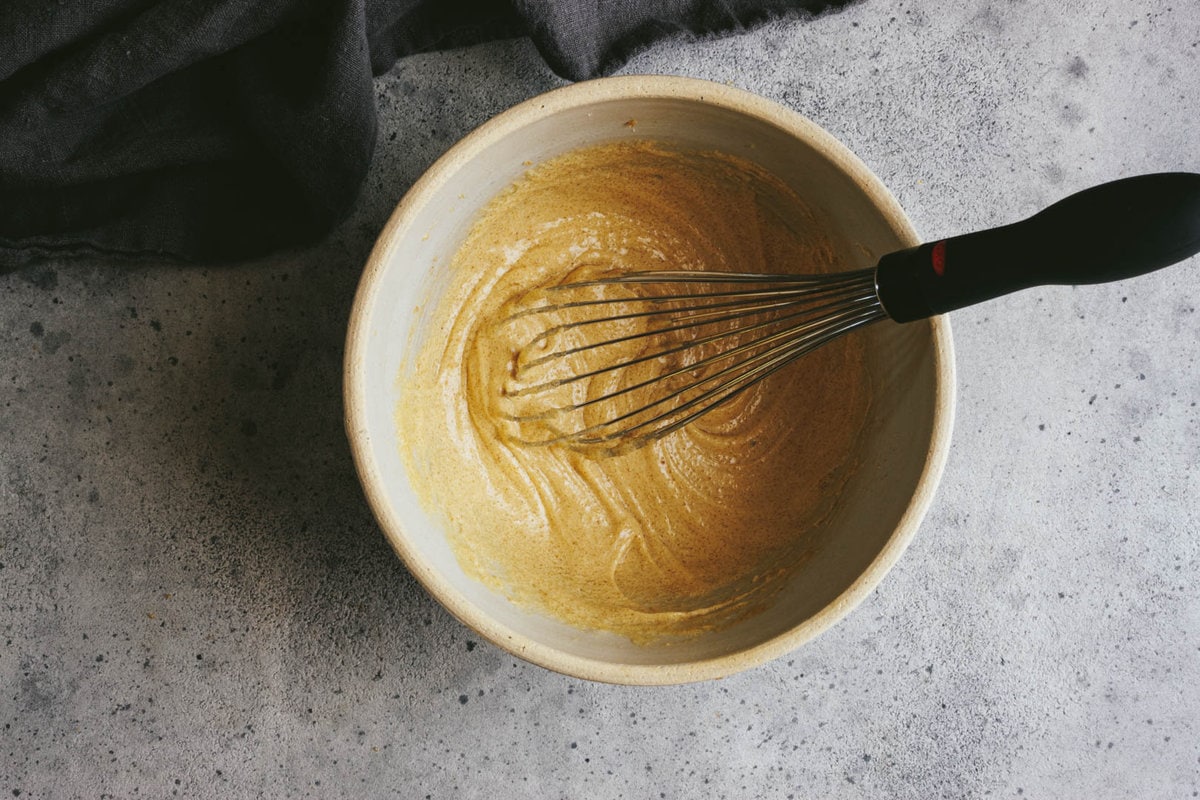 egg whisked into the butter and sugar mixture with a napkin on the side