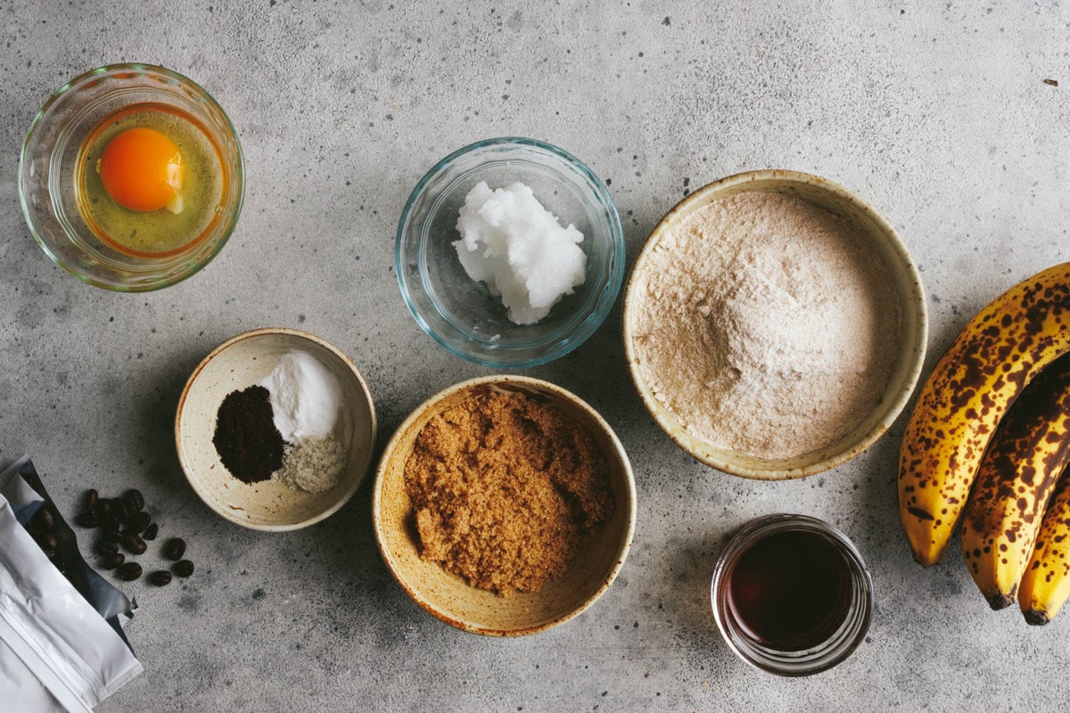 ingredients for maple cinnamon banana bread in different size bowls