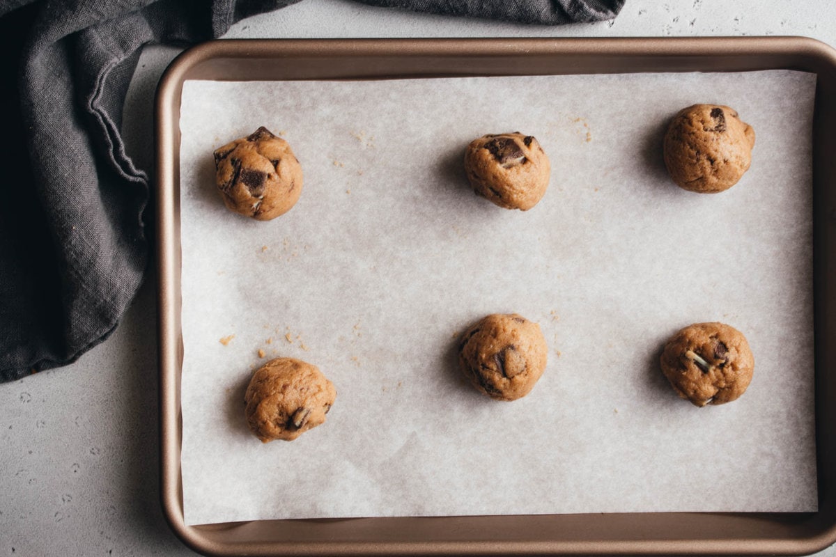 cookie dough bowls on a baking sheet with a napkin on the side