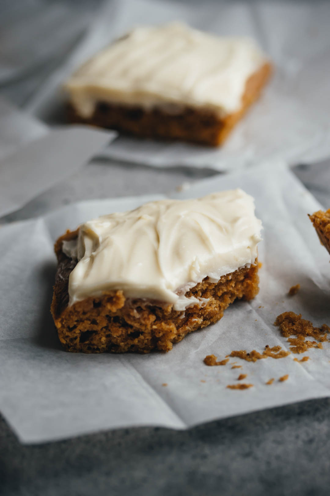 pumpkin bars on parchment paper with a fork on the side