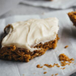 pumpkin bars on parchment paper with a fork on the side