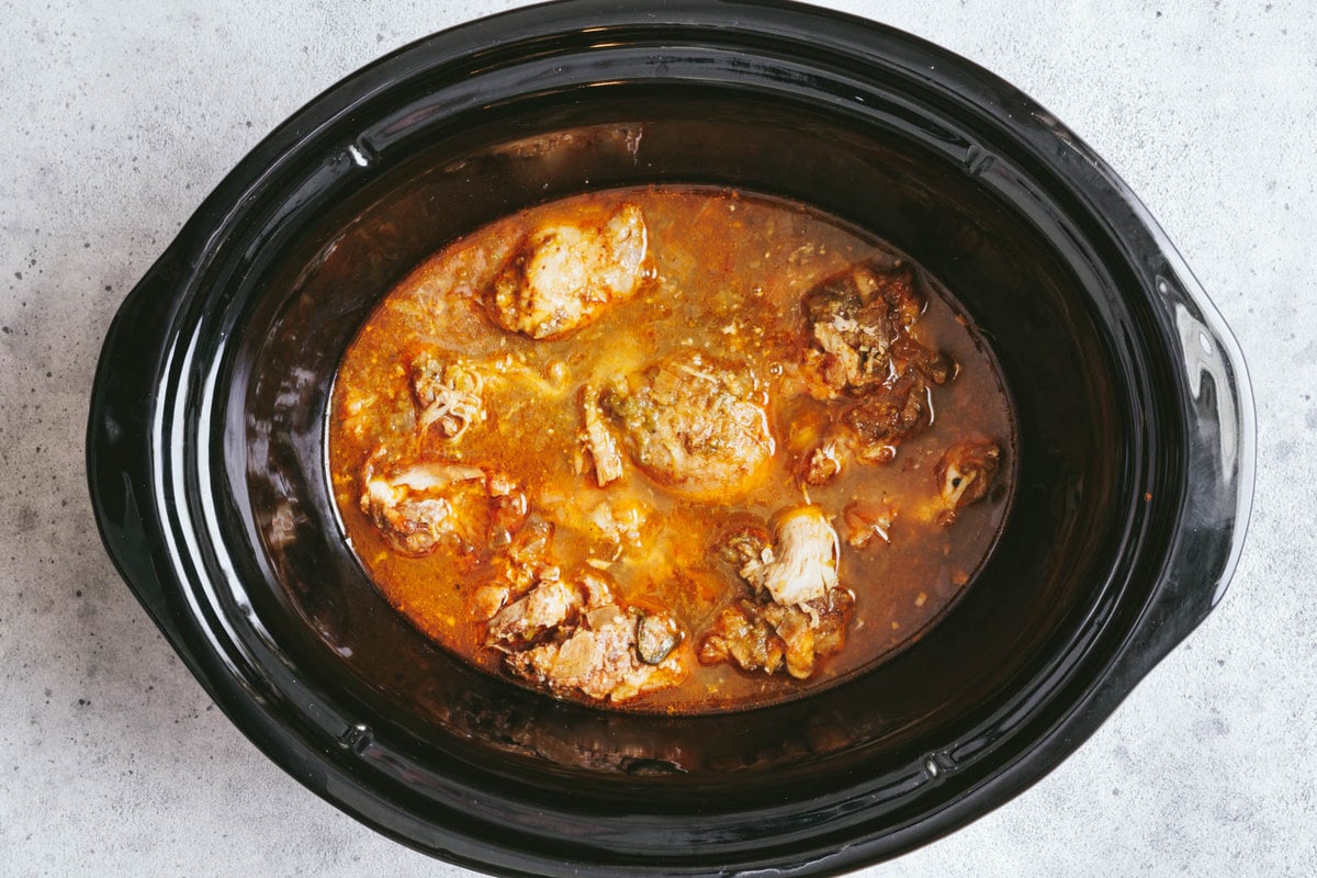Cooked chicken mixture in a slow cooker bowl